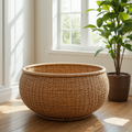Woven basket on a wooden floor with a plant in the background