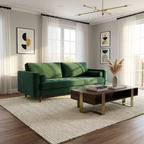 Green sofa in a living room with a coffee table and decorative elements.